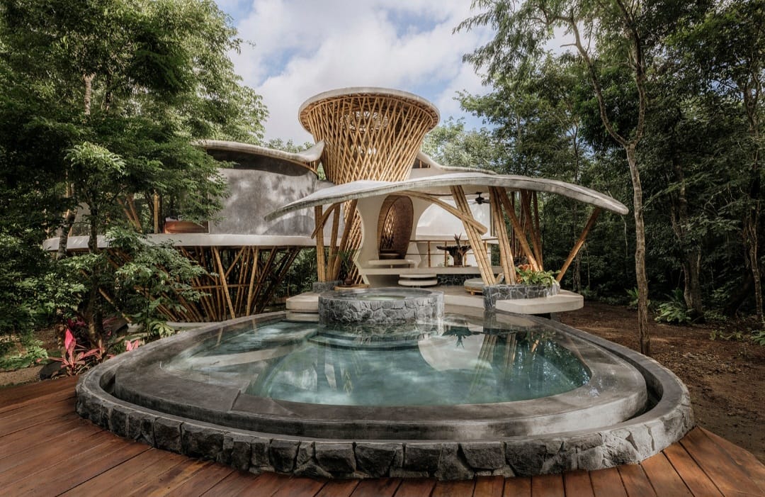 Natural stone pool in front of the bamboo pavilion at the Awakening Sanctuary during the day